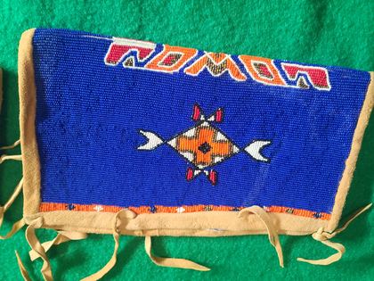 Matched pair of fully-beaded hide cuffs, cobalt field with crossed-arrow medallions, plate 77